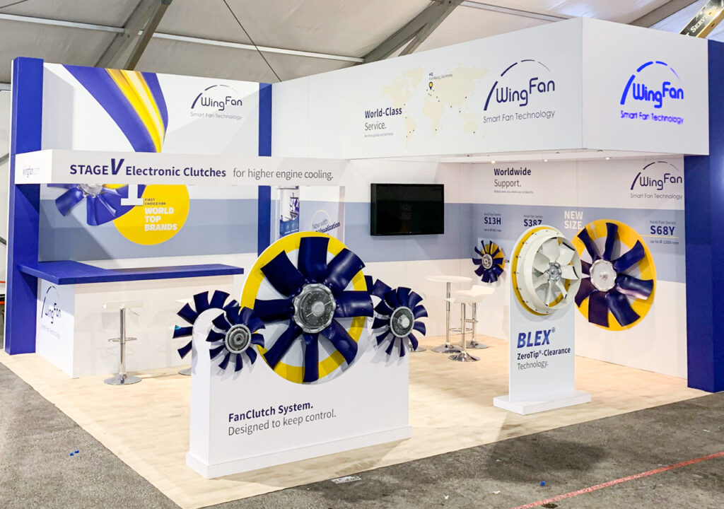 Industrial trade show booth displaying mechanical components and branded panels