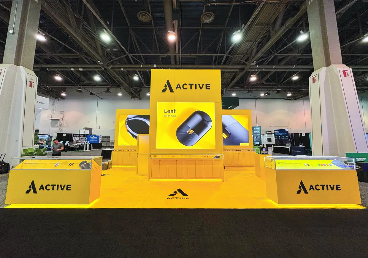 Front view of Active trade show booth with yellow counters
