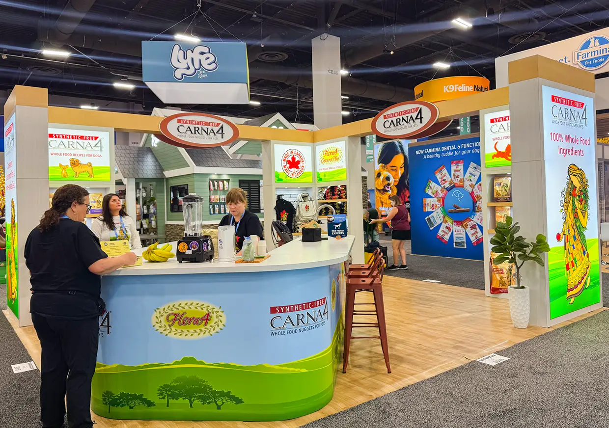 Visitors gathered at CARNA4 trade show booth reception counter