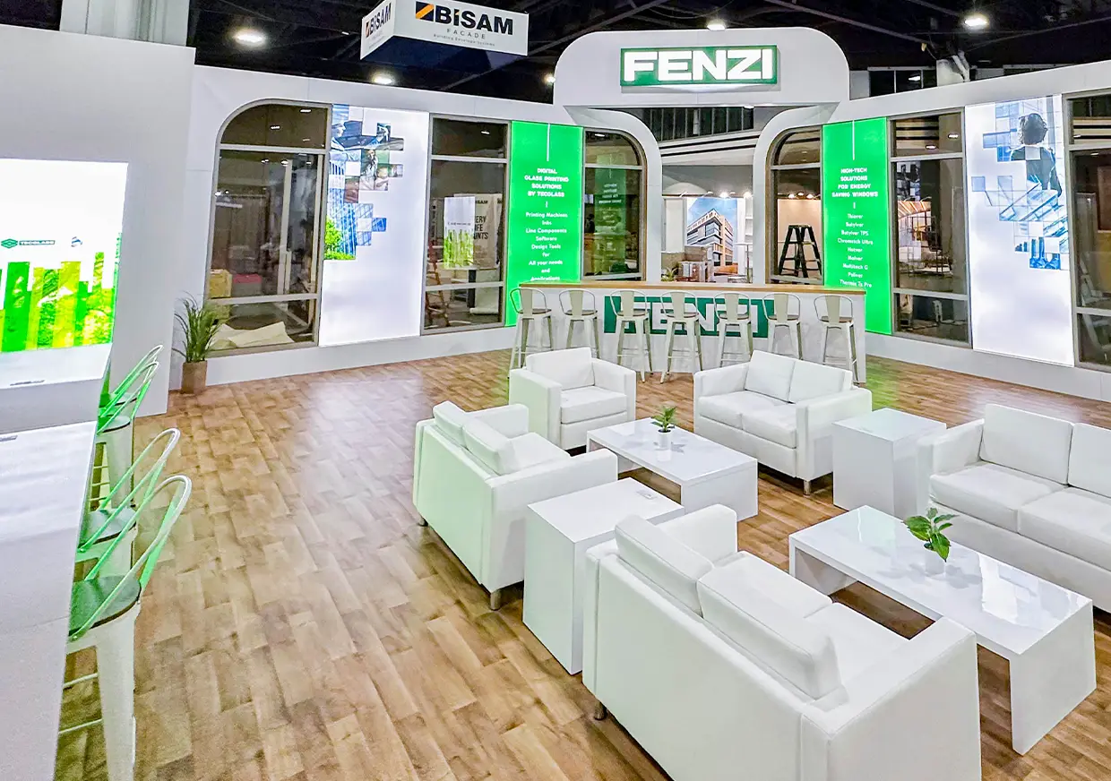 Fenzi booth interior featuring white sofas and green branded displays