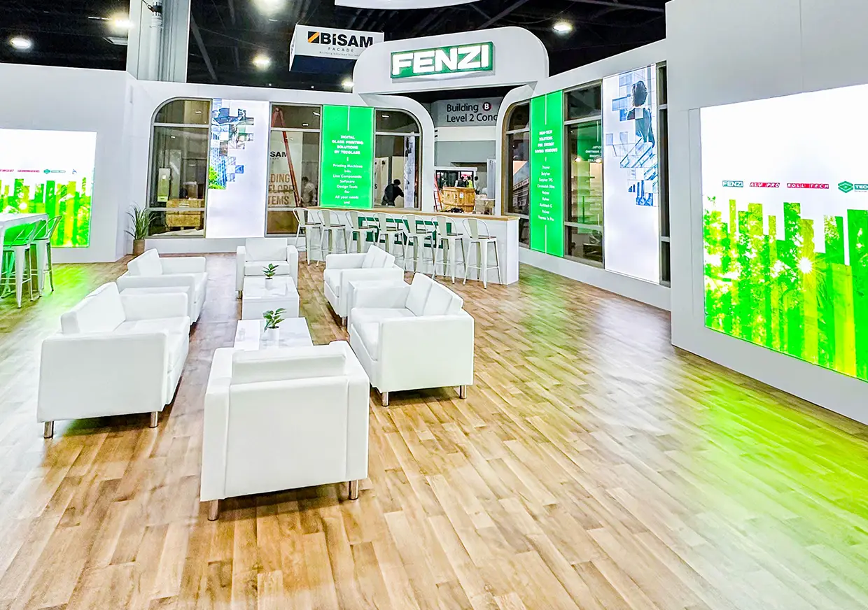 Fenzi exhibition lounge with illuminated green panels and white seating