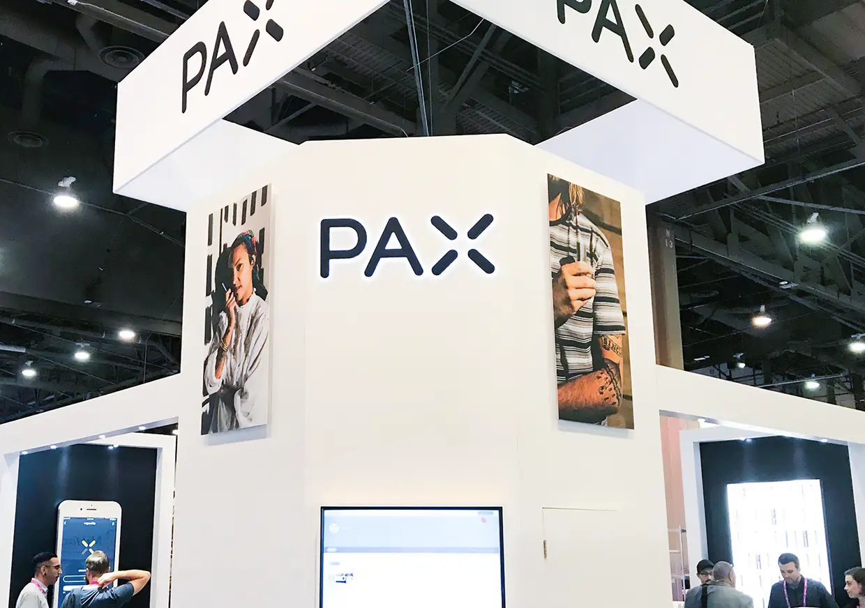 Close view of PAX exhibition structure with bold overhead branding