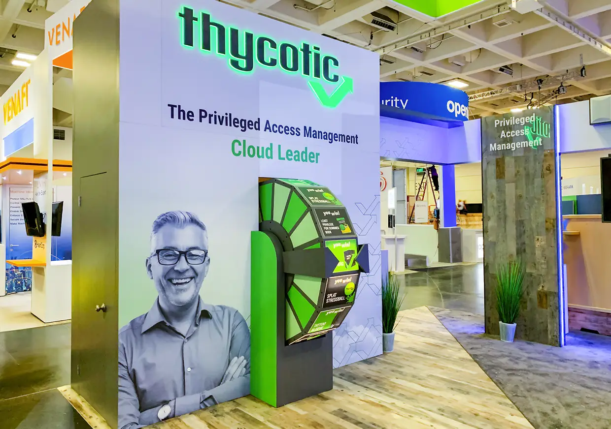 Thycotic booth entrance featuring green security graphics and branded signage