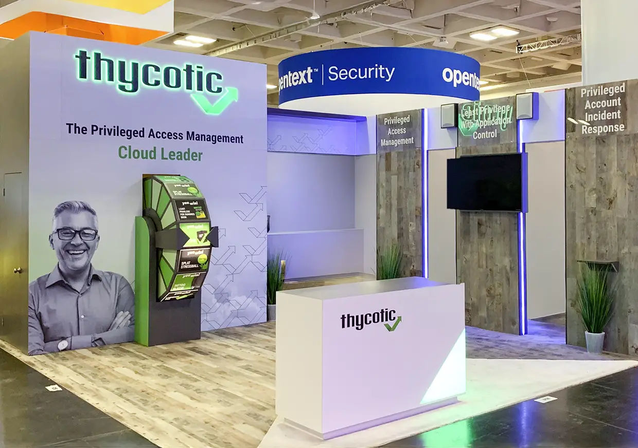 Front view of Thycotic cybersecurity booth with reception and screens